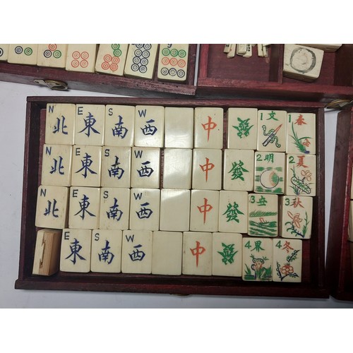 301 - A vintage Mahjong set, boxed; 2 large conch shells, other games etc.