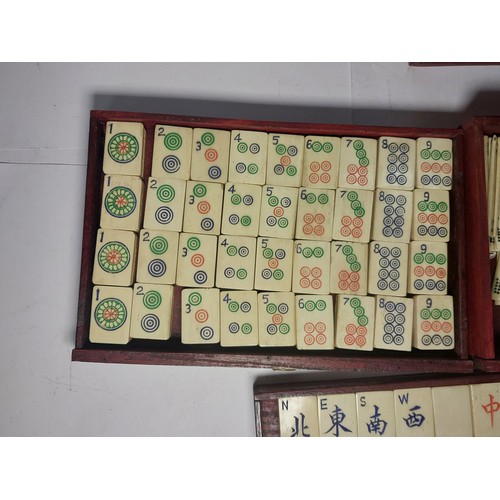 301 - A vintage Mahjong set, boxed; 2 large conch shells, other games etc.