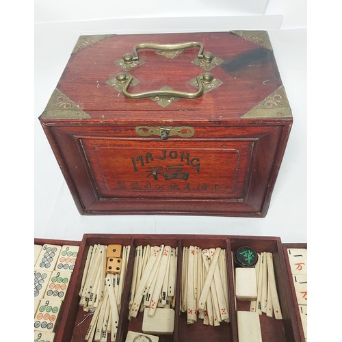 301 - A vintage Mahjong set, boxed; 2 large conch shells, other games etc.
