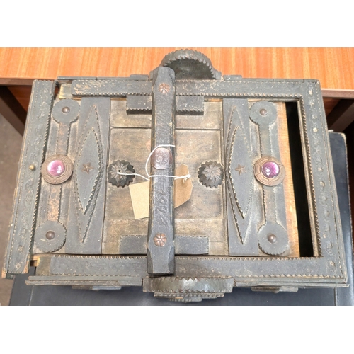 47B - A large carved wooden 'Tramp Art' box with sliding lid set with stones, length 33cm...