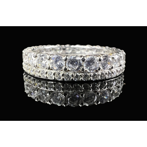 A modern silver ring set with multi coloured stones in rub over setting ...
