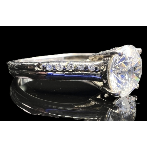 A modern silver ring set with multi coloured stones in rub over setting ...