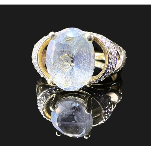 A 9 carat hallmarked gold dress ring set oval pale grey stone and illusion  set diamond chips to shou
