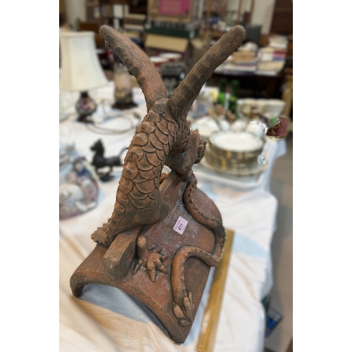5 - An oriental terracotta garden roof tile in the form of a dragon.