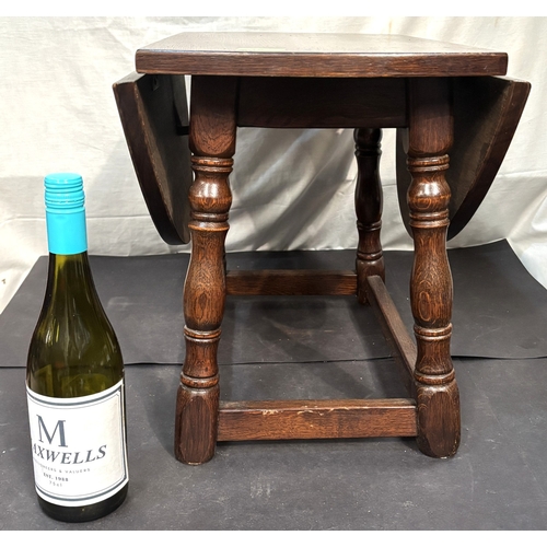 19 - An oak drop leaf table and child's guitar.