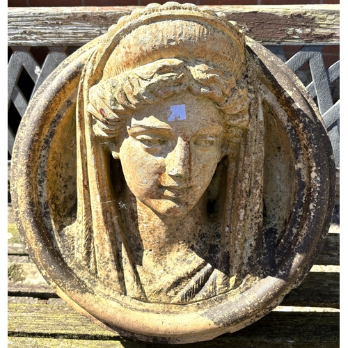 2 - A circular garden wall plaque depicting a classical female head in high relief, possibly Minerva, di... 