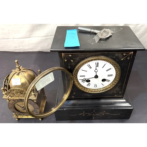 21 - An architectural black slate mantle clock with striking movement; a small reproduction brass lantern... 