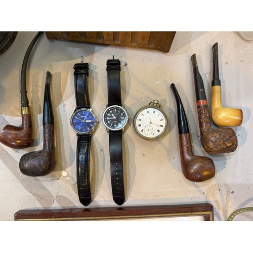 21A - A pocket watch; a Sekonda wristwatch and another; a selection of pipes etc.