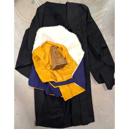 30A - A vintage metronome, a lecturer's cap and gown.