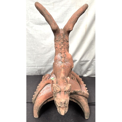 5 - An oriental terracotta garden roof tile in the form of a dragon.