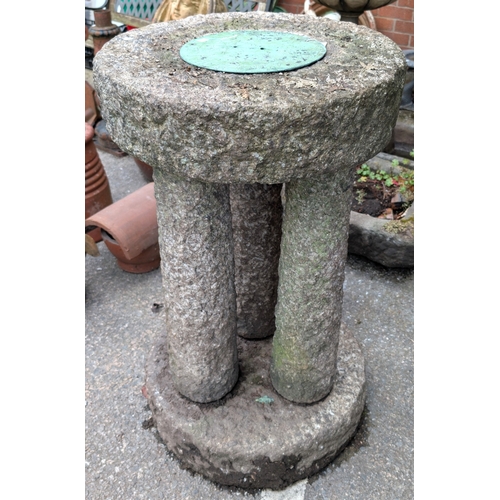 10C - A Scottish Granite circular rough hewn garden statuary on 3 columns, 95cm height x 54cm diameter.
