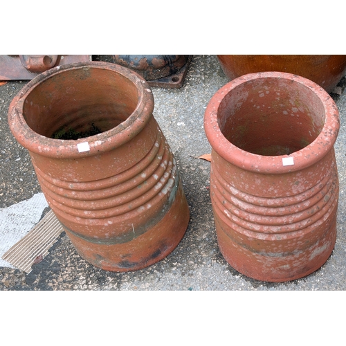 14B - A pair of early 20th century terracotta chimney pots/planters with covers