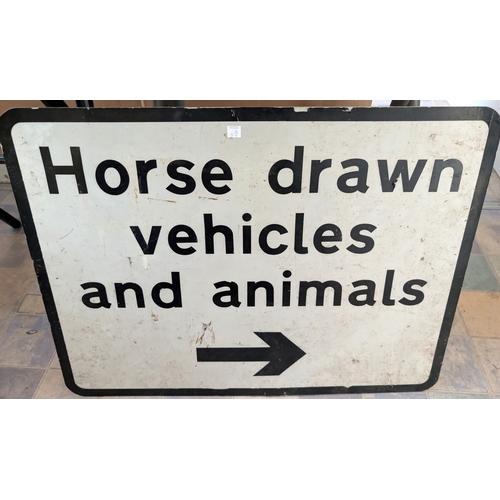 19B - A sign: Horse Drawn Vehicles and Animals this Way.