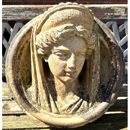 2 - A circular garden wall plaque depicting a classical female head in high relief, possibly Minerva, di... 
