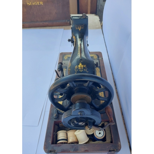 35 - A vintage early 20th century singer hand crank sewing machine with distinctive gingerbread pattern a... 