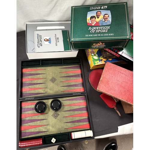 41 - A cased wooden chess set and various games.