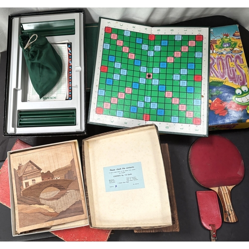 41 - A cased wooden chess set and various games.