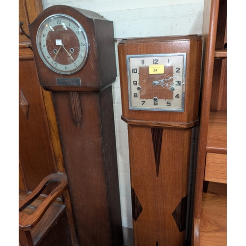 34 - An Art Deco granddaughter clock with inlaid case and another 1930's.