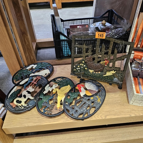 145 - Cast Iron Book Holder & 4 Trivets