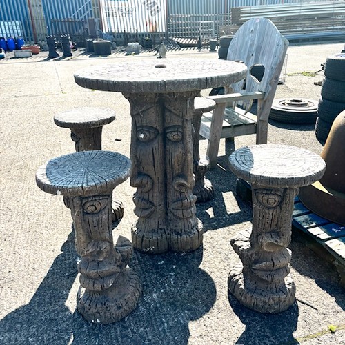 73A - An Ornate Concrete High Garden Table & 4 Matching High Stools, Depiciting Easter Heads