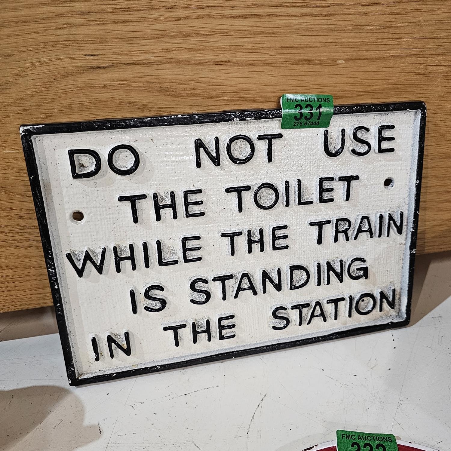 Cast iron 'Toilet When Train In Station Sign'