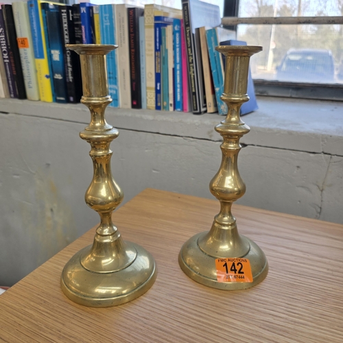 142 - An Old Pair Of Brass Candlesticks