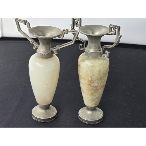 154 - Two heavy marble mantel ornaments, each topped by metal & handle,  designs and height not identical.... 