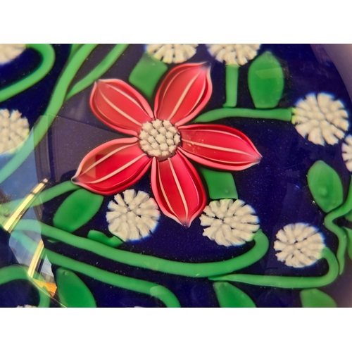 166 - Perthshire paperweight: 2001. Pink flower 7 white florets on blue Excellent condition. 74mm diam. Bo... 