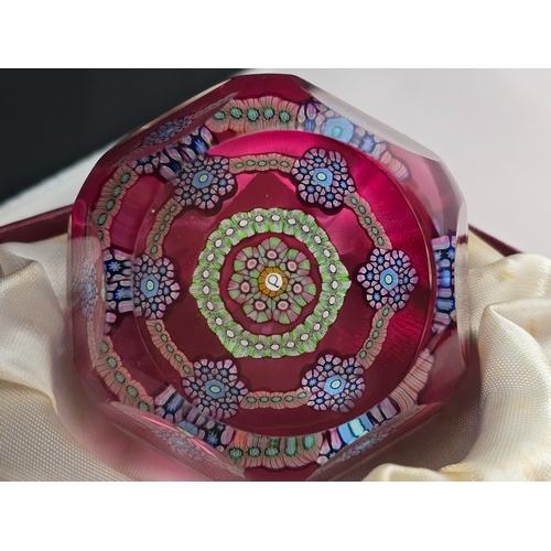171 - Perthshire Paperweight: PP77. Pretty medium Patterned millefiori weight on translucent pale ruby gro... 