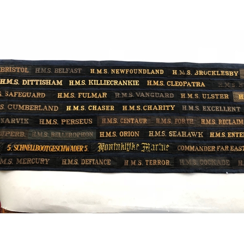 178 - Display of 93 Naval Cap Tallies/Ribbons.  An unusual dark blue cotton panel bearing approx. 93 name ... 