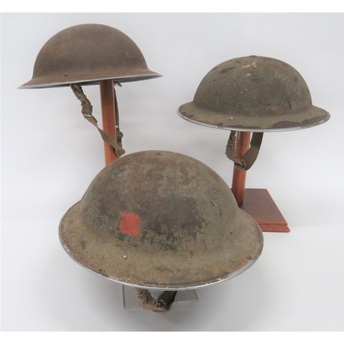 256 - Three Various British Steel Helmets MKII steel helmets, all complete with liners. Dated 1940 ... 193... 