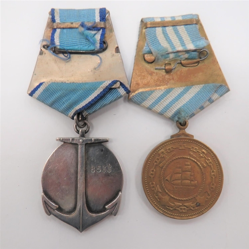 136 - Two Soviet Russian Naval Medals
consisting silvered Ushakov medal.  Reverse numbered 