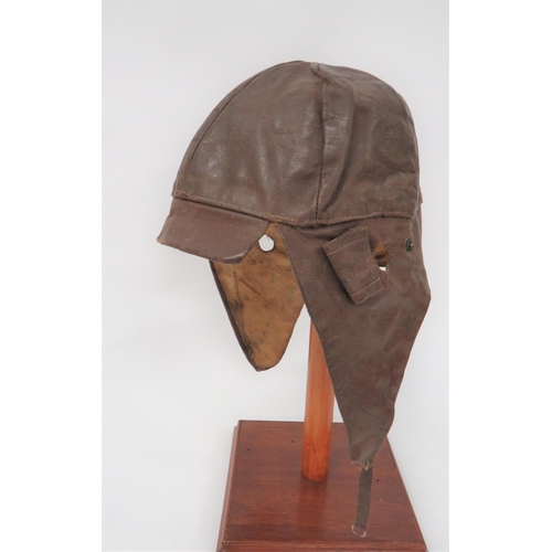 103 - Interwar Period Leather Flying Helmet
brown leather, multi panel helmet with small peak.  Roll up, l... 