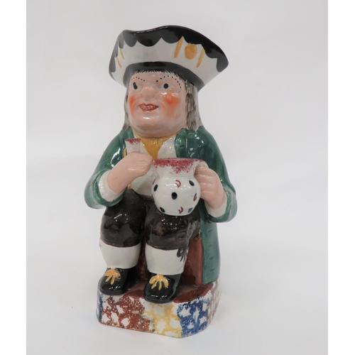 341 - 19th Century Toby Jug
green glazed jacket example.  Holding his tankard and jug.  Multi colour trico... 