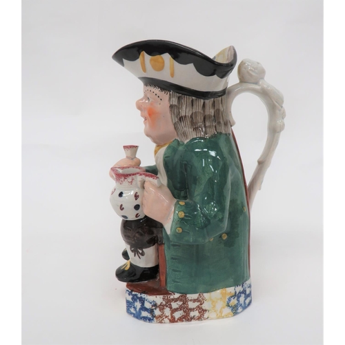 341 - 19th Century Toby Jug
green glazed jacket example.  Holding his tankard and jug.  Multi colour trico... 