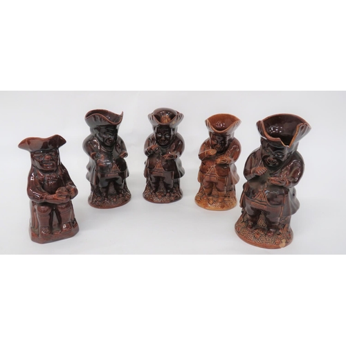 352 - Five Treacle Glazed Toby Jugs
consisting Rockingham treacle glaze, circa 1840, snuff taker jar.  The... 