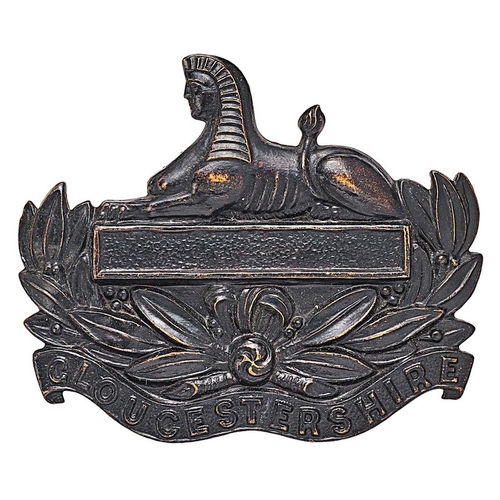 273 - 5th Bn. Gloucestershire Regiment cap badge circa 1908-20.  Good scarce die-stamped blackened brass S... 