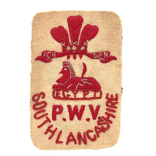 552 - South Lancashire Regiment cloth pagri badge.  White rectangle embroidered with red Prince of Wales p... 