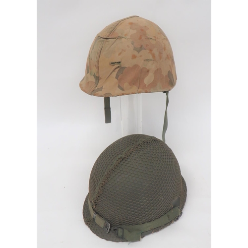 205 - Two Post WW2 American Steel Helmets
consisting green, rough texture shell with rear seam.  Fibr... 