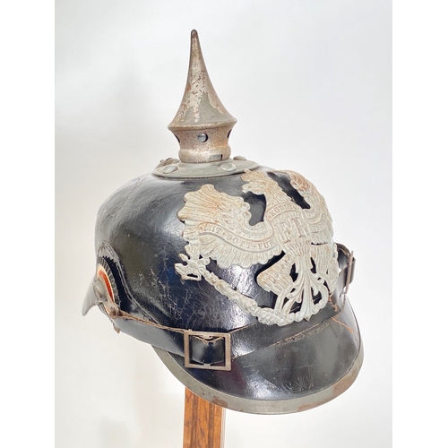 432 - Imperial German WW1 Prussian State Pickelhaube  A good example polished black leather skull, with gr... 