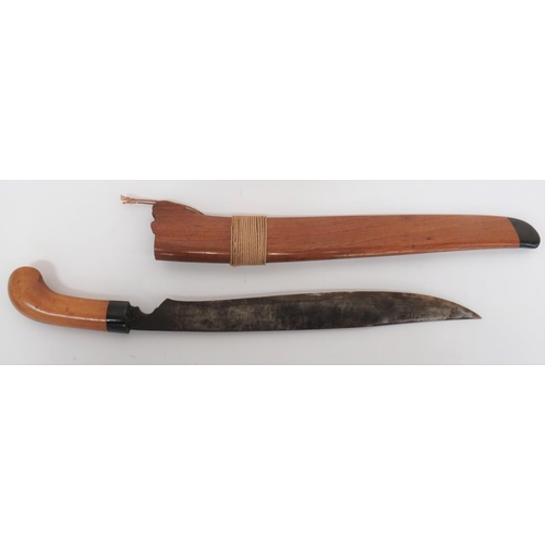 Malayan Parang Short Sword
12 1/4 inch, single edged blade widening towards the sharpened back edge point.  Horn ferrule and polished wooden grip.  Contained in its two piece wooden scabbard with lower horn chape and cord binding.