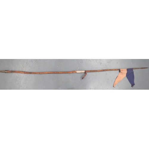 WW1 Period Indian Cavalry Lance
steel, hollow ground trefoil head.  Bamboo shaft with brown leather wrist strap and white cord rubbing mount.  Conical steel butt cap.  Complete with blue and white cotton pennant.  Some splits to the bamboo shaft.  