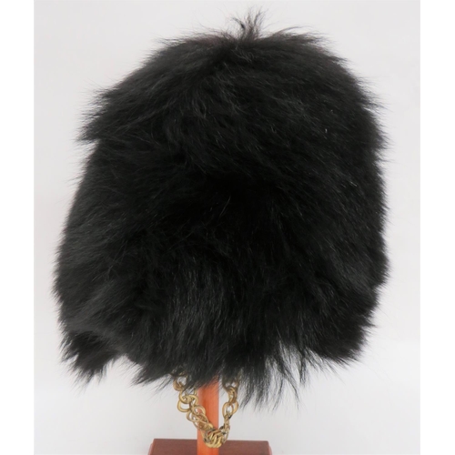 231 - Guards Bearskin
black, long fur body.  Internal wickerwork frame.  Leather, eight tongue l... 