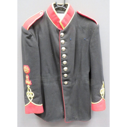 Post 1953 REME Warrant Officer Bandsman's Full Dress Uniform
black, single breasted tunic.  High scarlet collar with gilt cord edging.  Scarlet pointed cuffs with gilt cord Austrian knot decoration.  The right cuff surmounted by bullion embroidery, QC Bandsman badge and WOII rank badge.  Scarlet shoulder straps with gilt gimp edging.  Anodised, QC REME buttons.  Internal issue label.  Minor moth.  