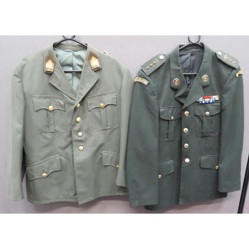 Two Continental Officer Jackets
consisting green, single breasted, open collar tunic.  Collar with gilt braid with bullion embroidery rank star tabs.  Gilt cord shoulder strap to one side only.  Gilt eagle buttons ... Dark green, Belgian Officer's, single breasted, open collar tunic.  Gilt collar badges.  Both arms with embroidery "Belgium" titles.  Brass rank stars.  Anodised buttons.  2 items.