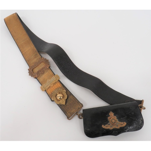Post 1901 Territorial Artillery Officer's Pouch and Shoulder Strap
black patent leather, rectangular pouch.  Full front flap with gilt, KC Territorial Artillery field gun badge.  Gilt brass acanthus leaf mounts.  Black leather strap with gilt braid facing.  Gilt acanthus leaf decorated buckle, slider and end mount with central flaming grenade.  Some service wear. 