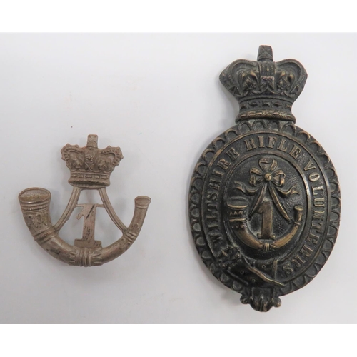 1st Wiltshire Rifle Volunteers Pouch Badge
cast, solid form brass belted oval inscribed "Wiltshire Rifle Volunteers" surmounted by a Victorian crown.  Central strung bugle with "1".  Two rear screw posts.  Together with a small white metal strung bugle surmounted by a Victorian crown.  Central "1".  1st Wiltshire Volunteers pouch badge.  Two rear screw posts.  2 items.