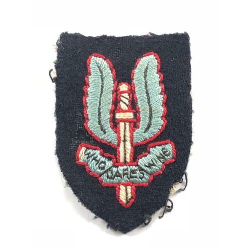 Special Air Service SAS cloth beret badge of Lt Col W.L. Mundell BEM A rare attributed example worn by Lt Col W.L. Mundell BEM the longest serving member of the SAS. This embroidered example has been worn. 