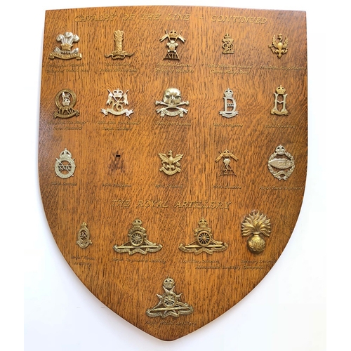 19 Cavalry & Artillery cap badges mounted on shield.   Good selection beautifully mounted on varnished wooden shield, each with gold illuminated script below. 10th Hussars ... 11th PAO Hussars (Firmin) ... 12th Lancers ... 13th/18th Hussars ... 14th/20th Hussars ... 15th/19th Hussars ... 16th/5th Lancers (anodised) ... 17th/21st Lancers ... 22nd Dragoons ... 23rd Hussars ... 24th Lancers ... 26th Hussars ... 27th Lancers  (Firmin) ... R. Tank Regiment. RHA ... RA ... HAC Artillery ... HAC Infantry ... R.Malta Artillery. All complete with fixings.  (19 items)