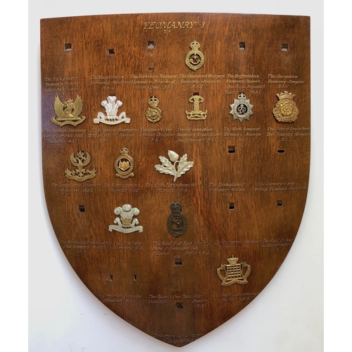 101 - 13 Yeomanry cap badges mounted on shield.   Good selection beautifully mounted on varnished wooden s... 